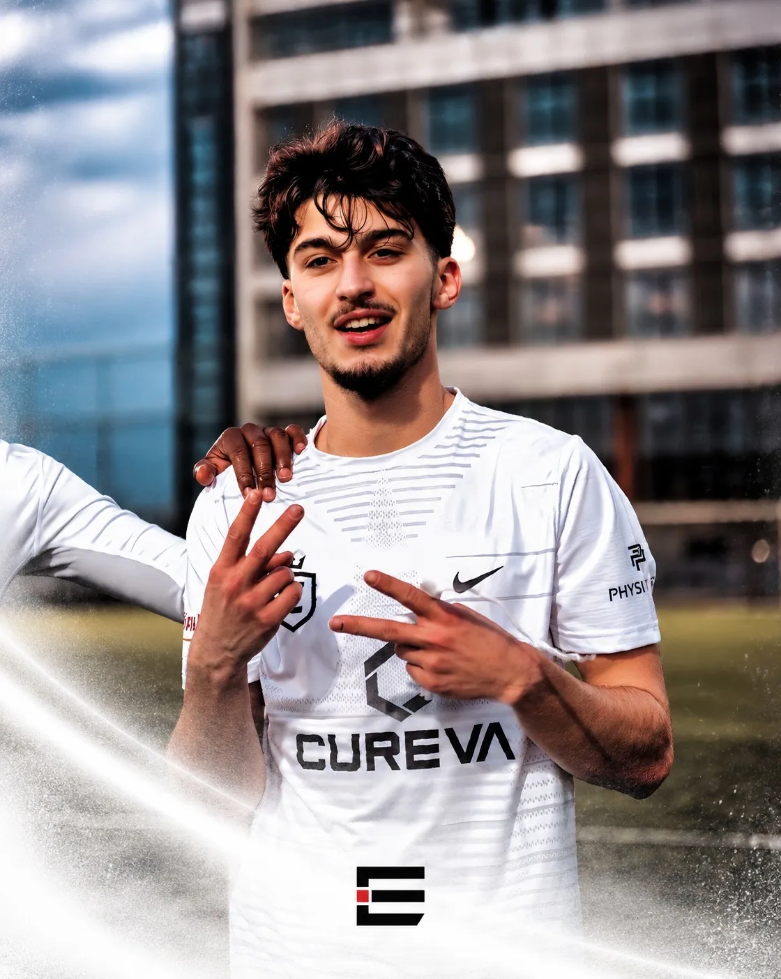 An Elite Icons player in a white match shirt beside the pitch