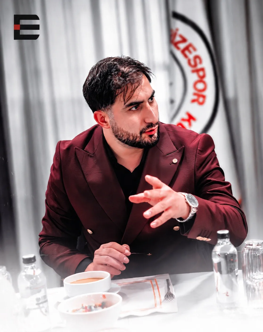 A conversation around the table with a Rizespor emblem in the background