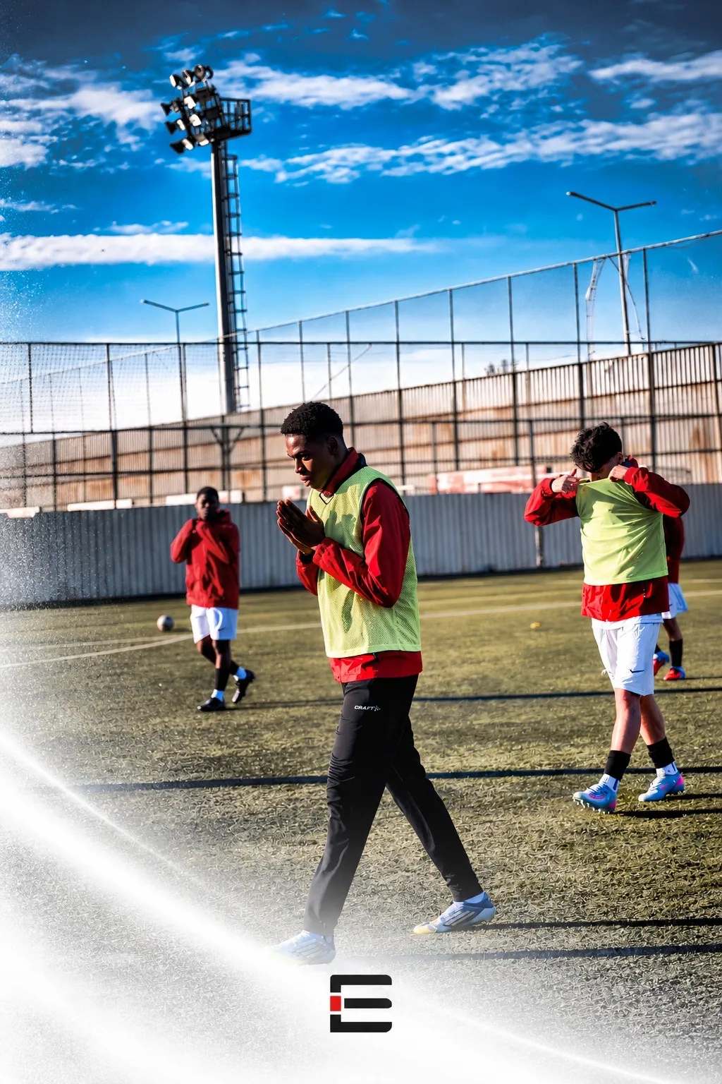 Elite Icons players preparing for training in red jackets and green bibs