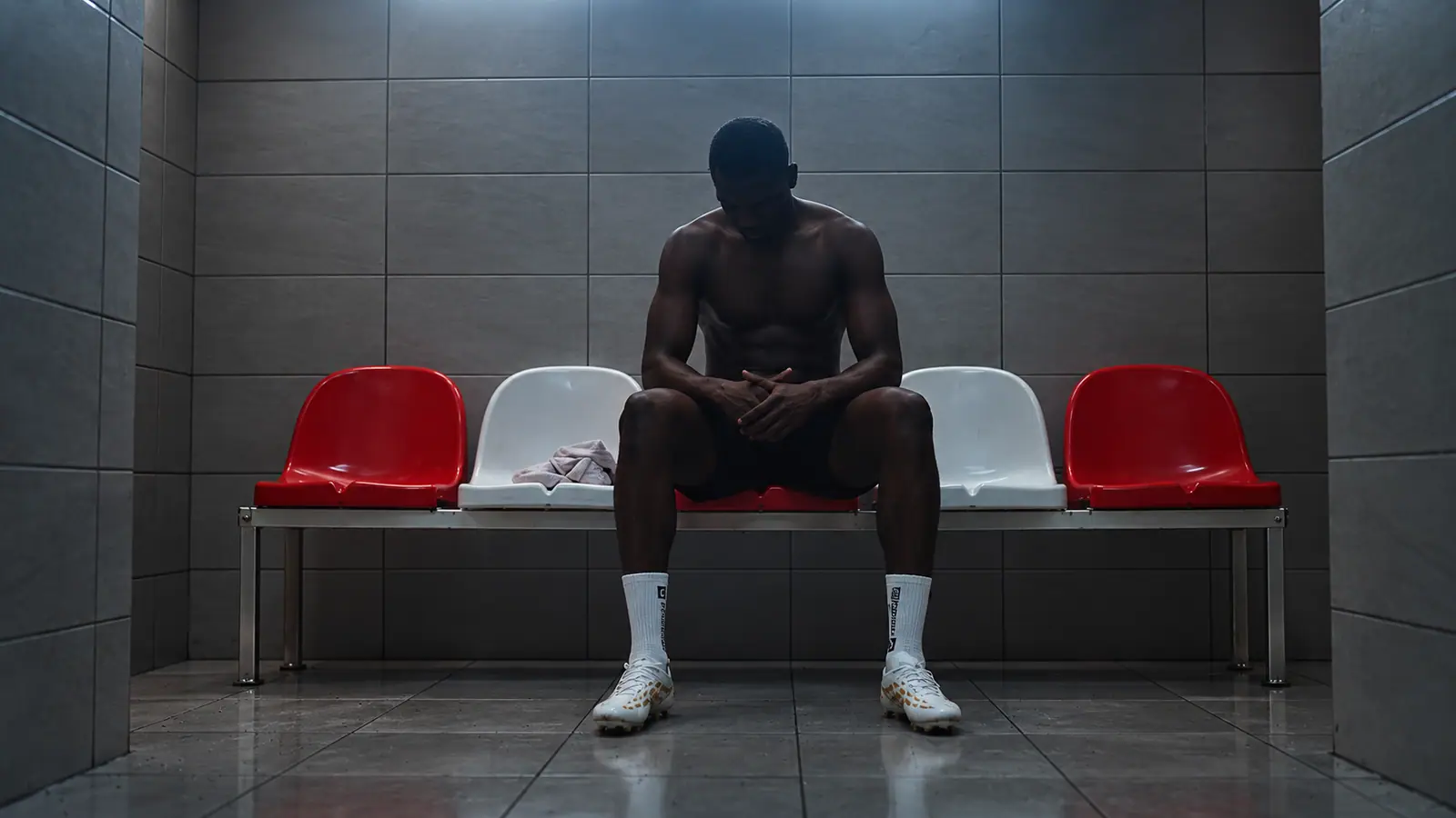 A footballer in a quiet locker-room moment before the match